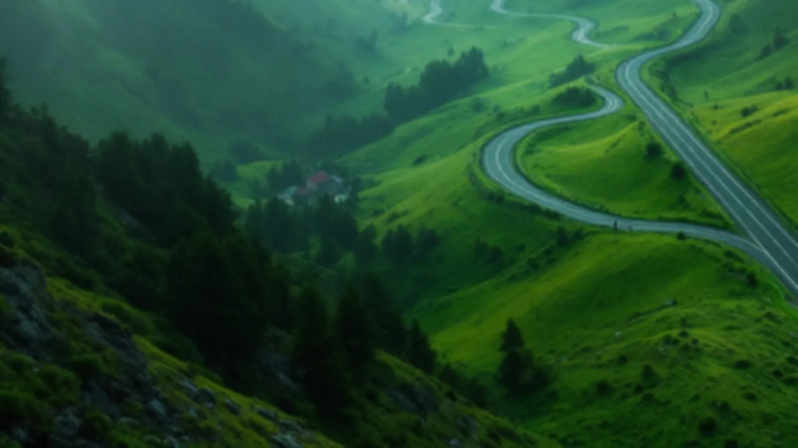An empty switchback road winding down a green valley in soft morning haze, the GearboxYield view of installment loans online, $100 – $5,000